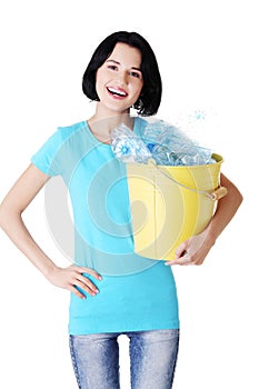Attractive woman holding bin with plastic bottles. recycling.