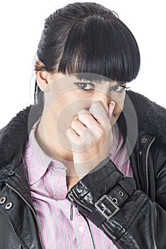 Attractive Woman Holding Her Nose to Stop a Bad Smell or Aroma