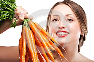 Attractive woman holds bunch of carrots