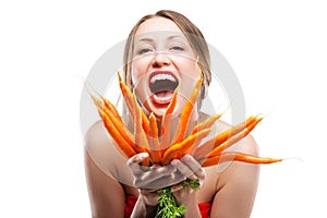 Attractive woman holds bunch of carrots