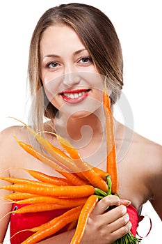 Attractive woman holds bunch of carrots