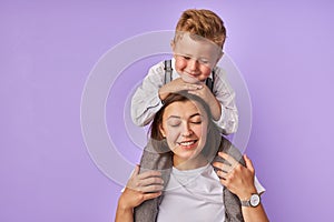 Attractive woman holds her child on neck