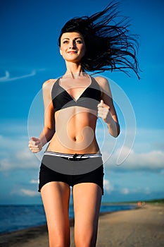 Attractive woman jogging on the beach