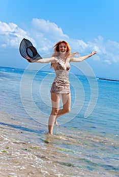 Attractive woman jumping in the sea