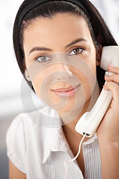 Attractive woman with landline phone