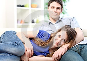 Attractive woman lengthened on the thighs of her boyfriend photo