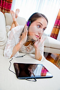 Attractive woman listen music on sofa