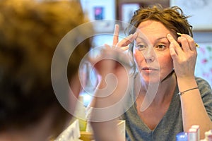 Attractive woman looking at her reflection