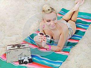 Attractive woman lying on the beach with vintage colorful detail