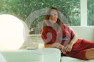 Attractive woman lying on a white sofa