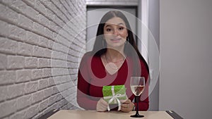 Attractive woman making surprise give present distance by video call, online