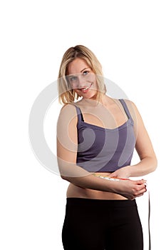 Attractive Woman measuring herself with a tape