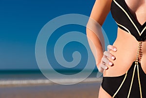 Attractive Woman in monokini on beach photo