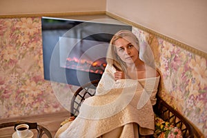 Attractive woman near the fireplace. Girl near the fireplace