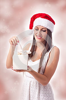 Attractive woman is opening a gift