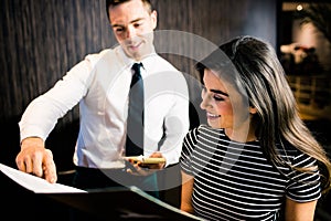Attractive woman ordering to the waiter from the menu photo