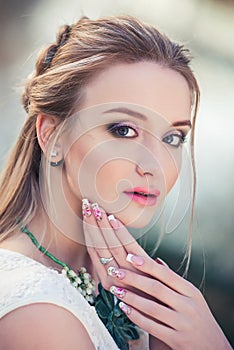 Attractive woman outdoors beauty portrait. Romantic girl with beautiful nails