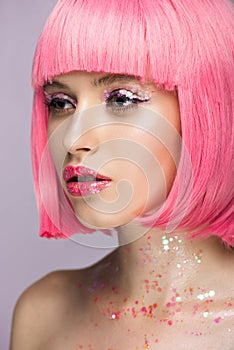 attractive woman with pink hair and makeup with glitter looking away