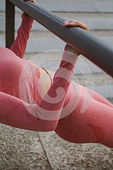 Attractive woman in pink red sportswear. Concept of fashionable sport outfit, vertical photo. The concept of sports, healthy