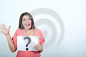 Attractive woman in pink shirt keeping whine paper with question mark
