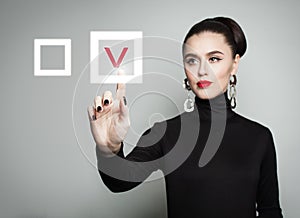 Attractive woman pointing her finger at red checkmark