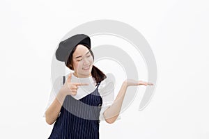 Attractive woman pointing and presenting product with empty hand in white isolated background.