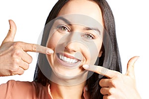 Attractive Woman Pointing To Her Smile With Perfect White Teeth photo