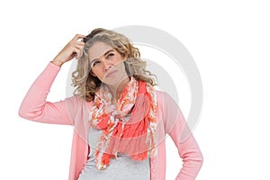 Attractive woman posing and smiling while scratching her head