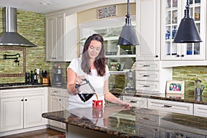 Attractive woman pouring homemade coffee for two in modern sunny kitchen