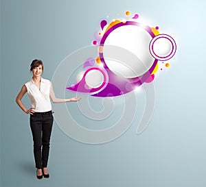 Attractive woman presenting abstract speech bubble copy space