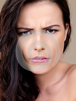 Attractive woman with a puzzled frown