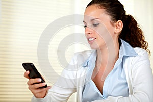 Attractive woman reading a message on cellphone