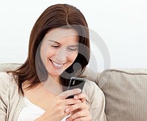 Attractive woman reading a sms on her cellphone