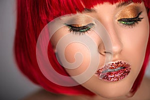 attractive woman with red hair and glittering makeup