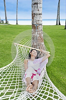 Attractive woman relaxing in Bali resort beach