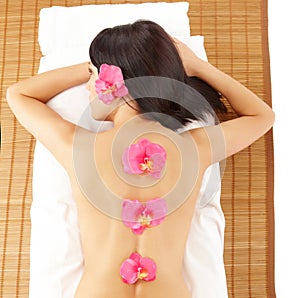 Attractive Woman Relaxing Spa with Flowers