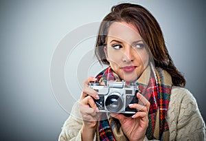 Attractive woman with a retro camera