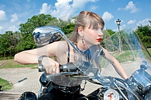 Attractive woman ride a black motorbike