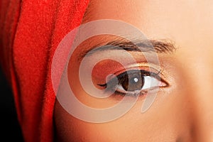 Attractive woman's eye. Woman in turban. Closeup.