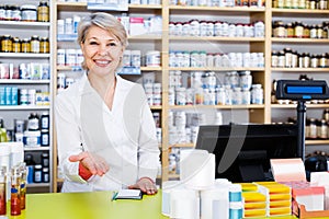 Attractive woman seller showing assortment of care products