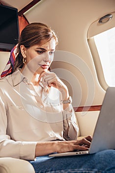 Attractive woman in shirt using laptop