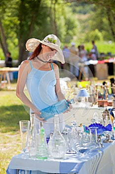 Attractive woman shopping for antiques, Provence, France.