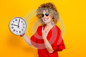 Attractive woman with short curly hair with clocks