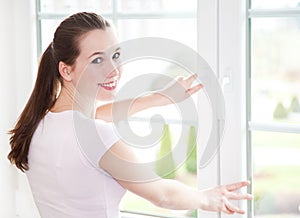 Attractive woman shuts window