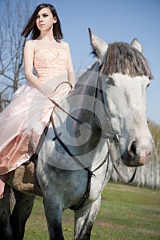 Attractive woman is sitting on the horse