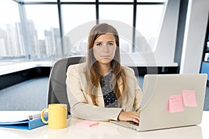 Attractive woman sitting at office chair working at laptop computer desk