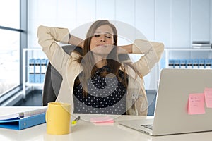 Attractive woman sitting at office chair working at laptop computer desk