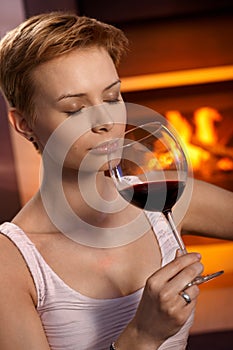 Attractive woman smelling glass of wine