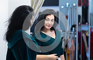 Attractive woman smiling at her reflection