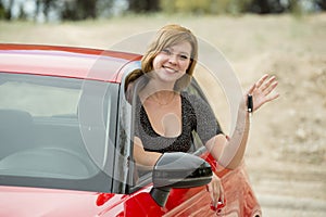 Attractive woman smiling proud sitting at driver seat holding and showing car key in new automobile buying and renting